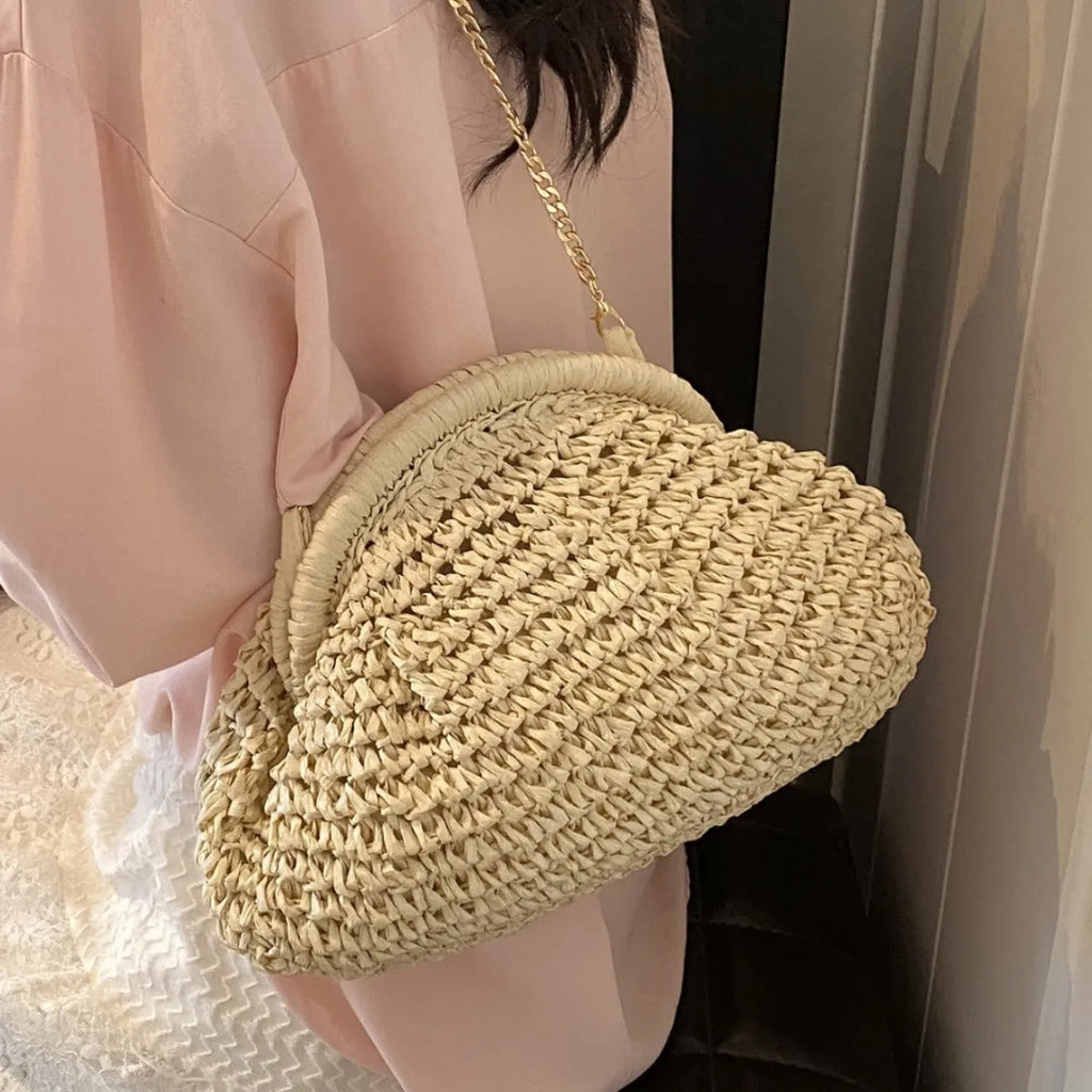 Women's shell-shaped straw shoulder bag with chain strap in khaki colour showing zippered internal pocket