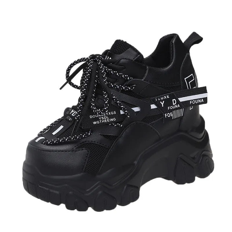 White women's low-top mesh sneakers with a black cross strap and a thick rubber platform sole.