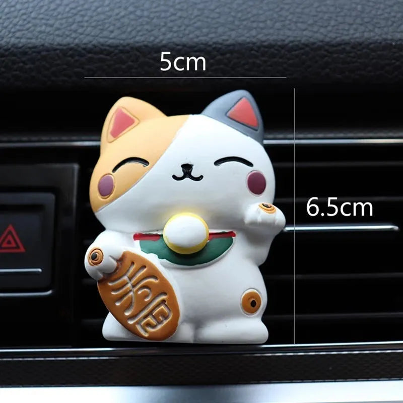 Black and white resin fortune cat decorative clip for car air conditioning vent with aromatherapy function.