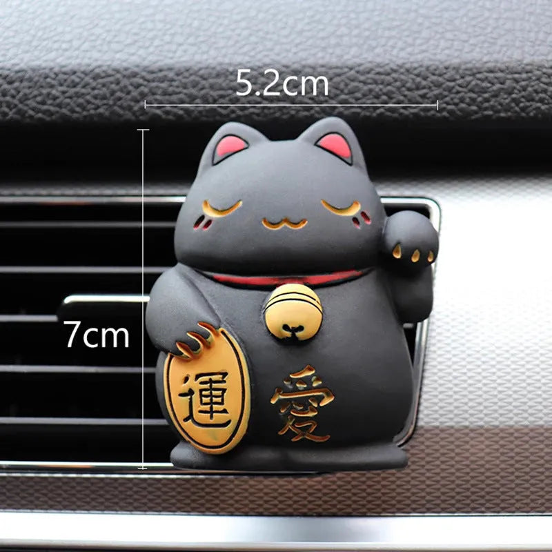 Black and white resin fortune cat decorative clip for car air conditioning vent with aromatherapy function.
