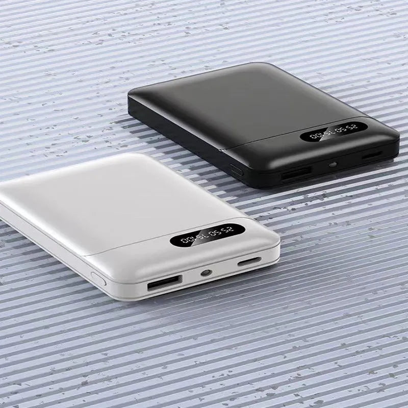 Black and white portable power bank charger with multiple USB ports and compact rectangular design