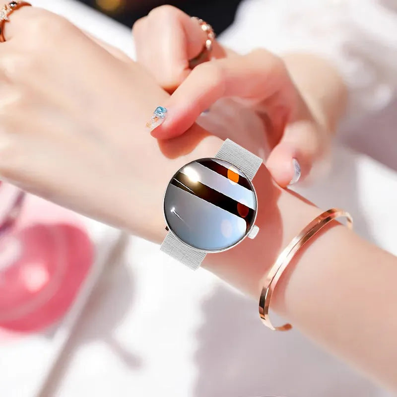 Women's smart watch with circular colour screen and metal strap showing health monitoring interface