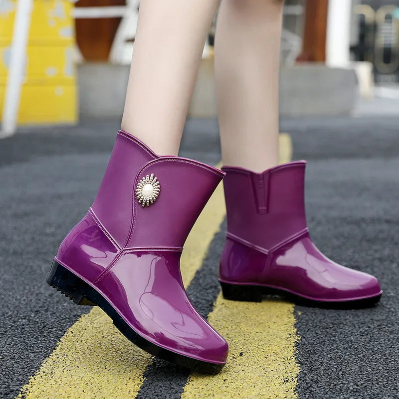 Women's purple PVC rain boots with a middle tube height and textured non-slip sole.