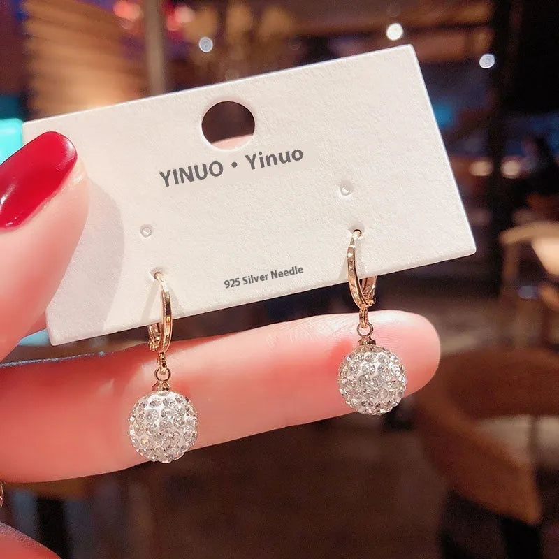 A pair of women's geometric copper earrings with rose details and an electroplated finish.