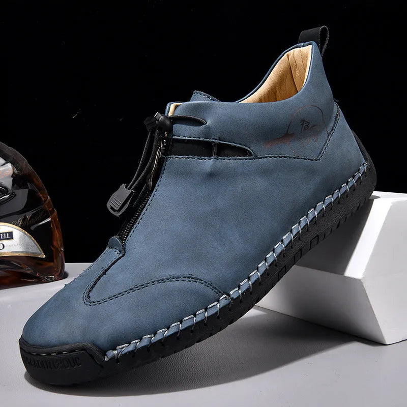Men's black casual leather shoe with mid heel, rounded toe, and sewing thread detail on a white background.
