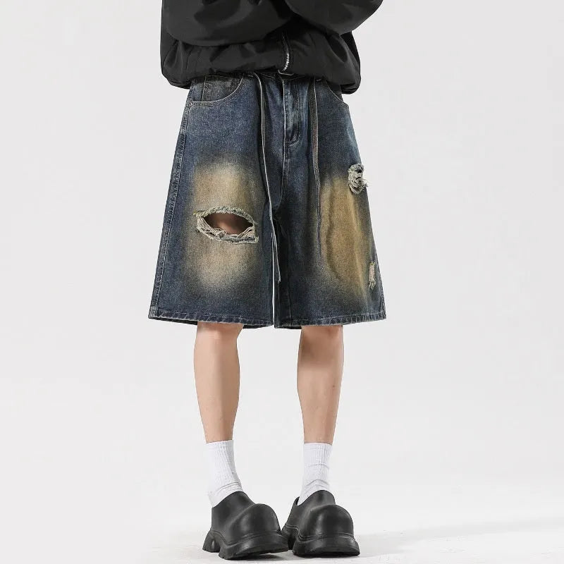 Men's loose fit ripped jeans in retro blue denim with distressed detailing and street style design