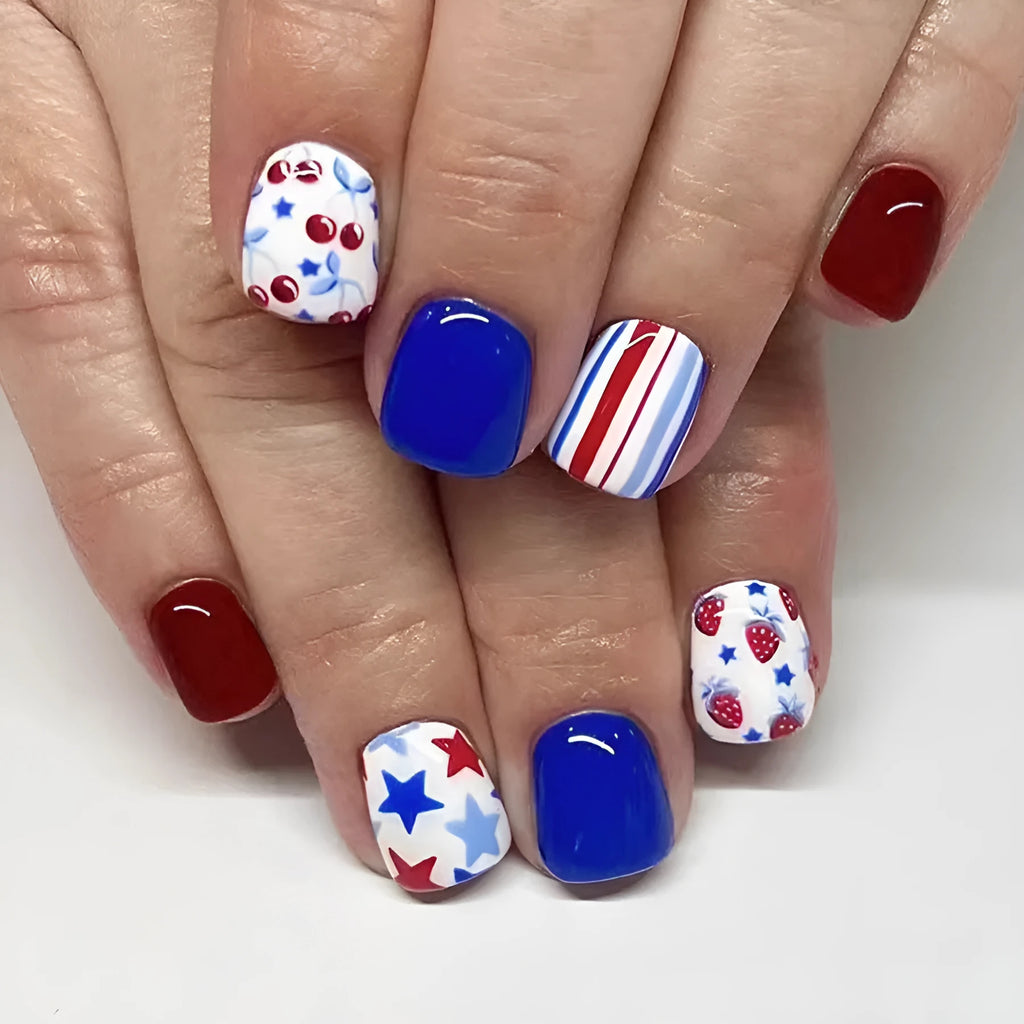 24 short glossy false nail stickers with strawberry and cherry patterns in red and blue colours
