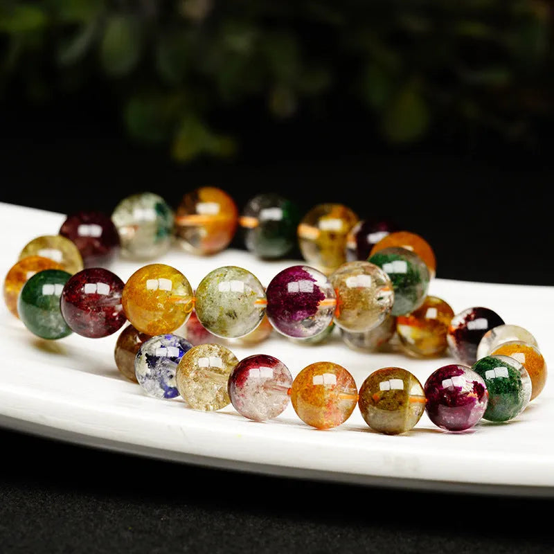 Natural crystal bracelet with 10mm beads showing ghost cornucopia ethnic design
