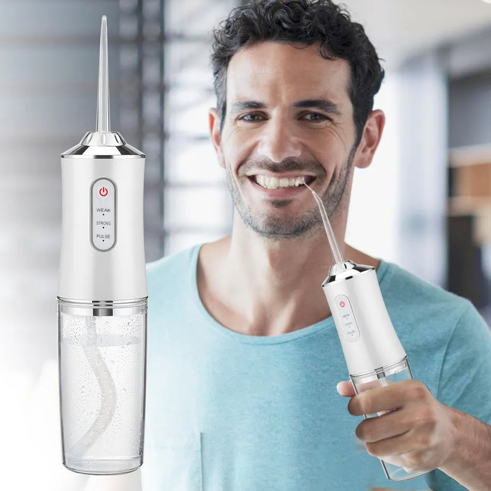 Handheld electric water flosser in white, pink, light green, or white-green with three speed settings, four nozzles, and USB cable