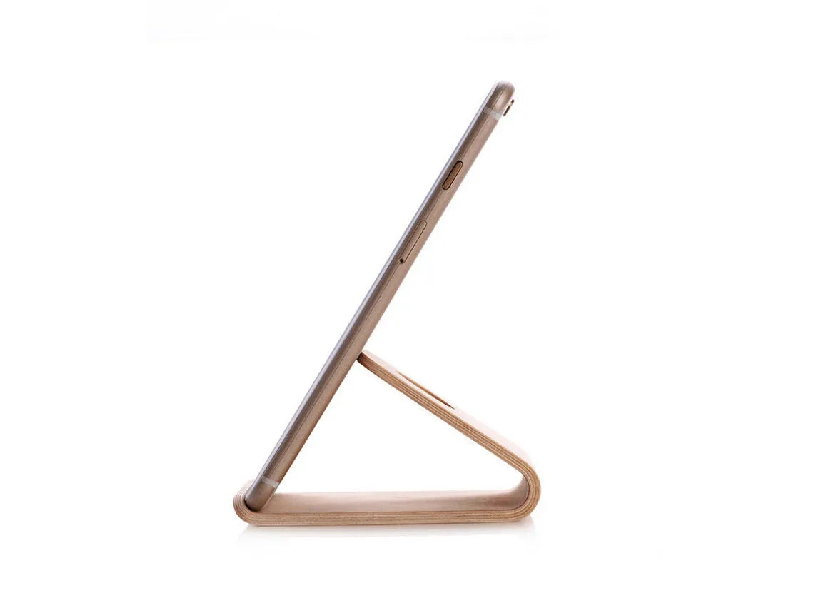 Wooden phone stand in walnut brown and white maple holding an iPhone upright on a desk.