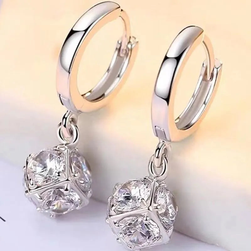 A pair of women's geometric copper earrings with rose details and an electroplated finish.