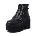 Black women's punk ankle boots with bat buckle detail, chunky heel, and side zipper.