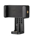 Black plastic rotating clamp phone holder with integrated note folder on a desk edge.