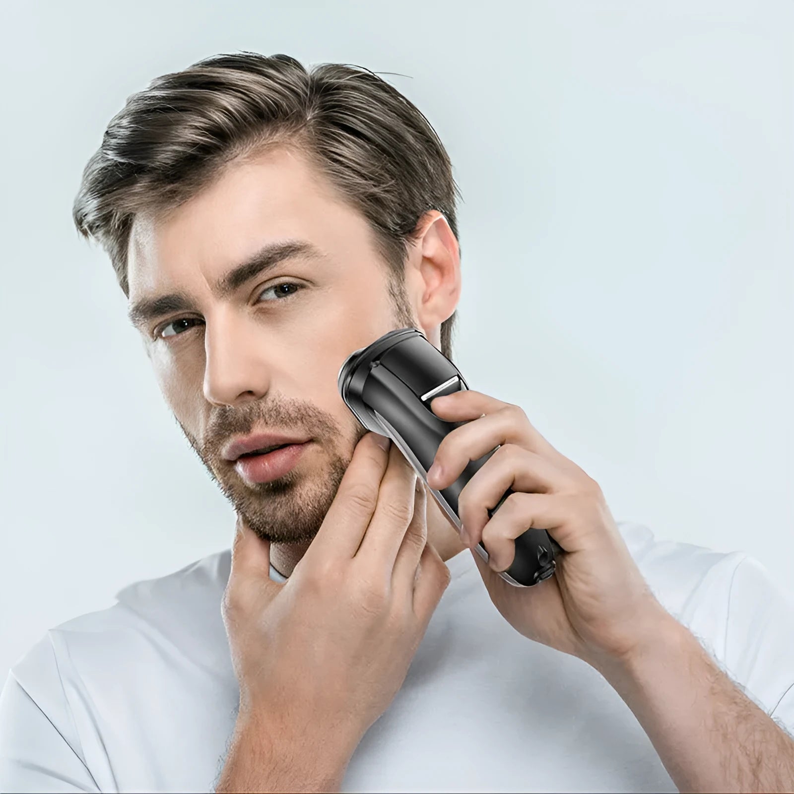 Men's electric shaver and grooming kit with three rotating heads, pop-up trimmer, USB cable, and cleaning brush.