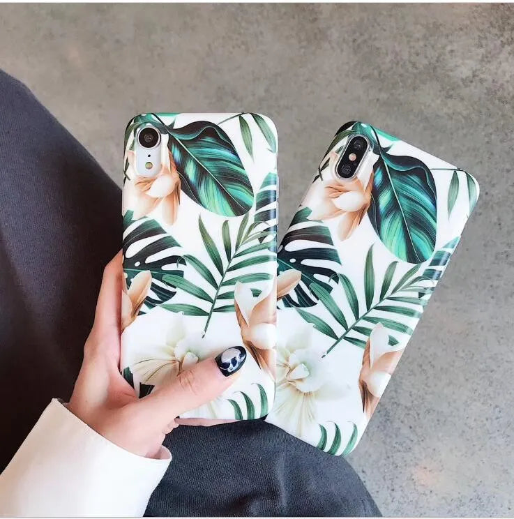 Soft TPU iPhone case with green banana leaf and pink floral art design on a white background.