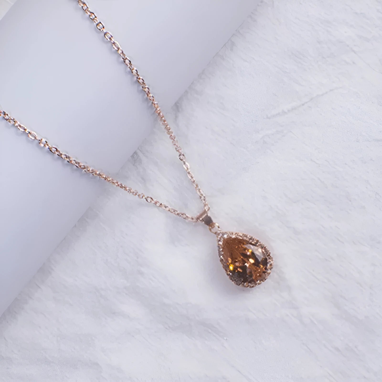 Rose gold water drop necklace with geometric rhinestone pattern in pink colour
