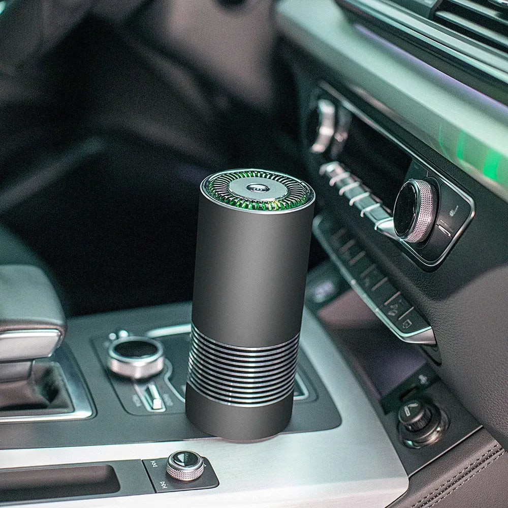 Compact cylindrical car air purifier in metallic grey showing 65mm diameter, with USB power cable.