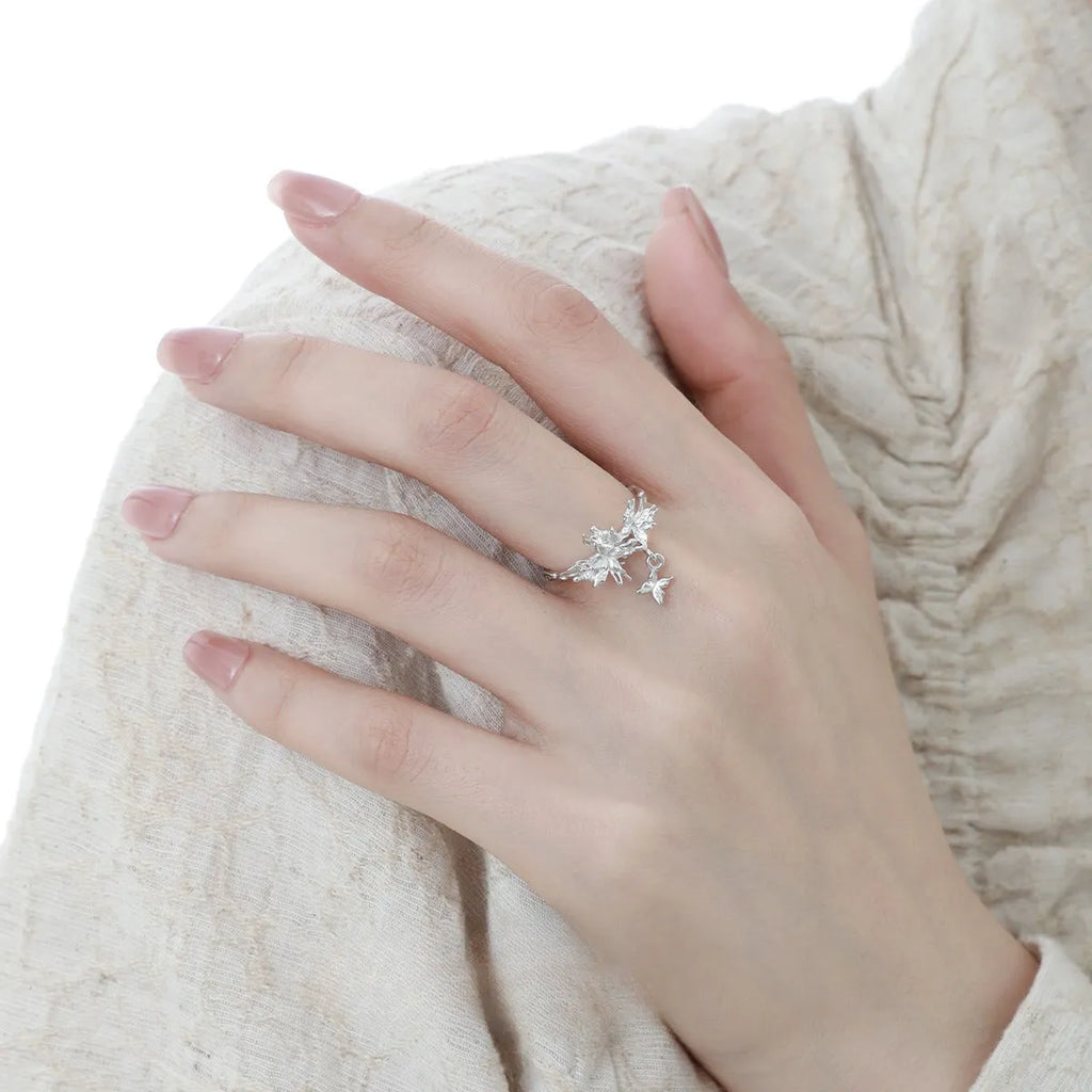 Adjustable silver butterfly ring with gold electroplating on model's finger