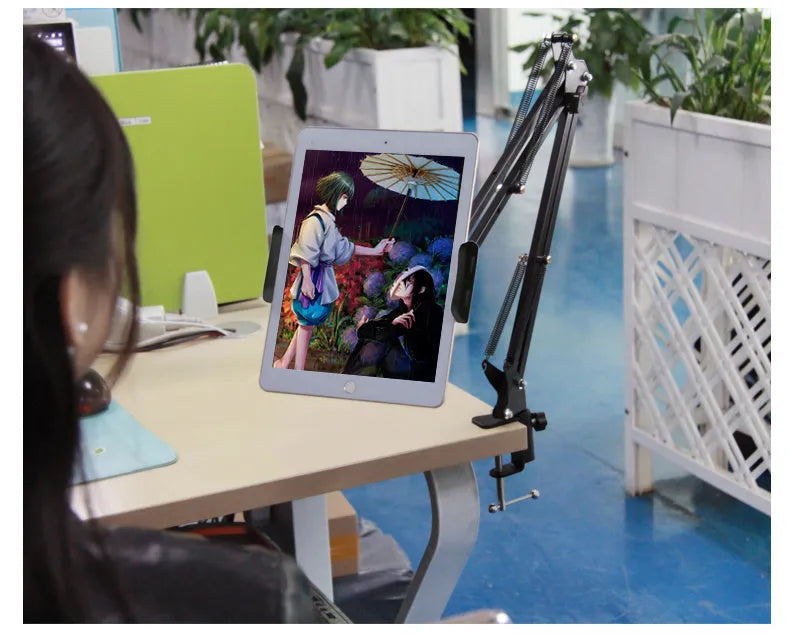 Black and white adjustable phone and tablet stand on desktop showing viewing angle