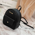 Small black PU leather ladies backpack with zipper, shown on shoulder