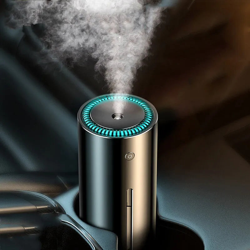 Black aluminium USB car humidifier and essential oil diffuser on a car dashboard.
