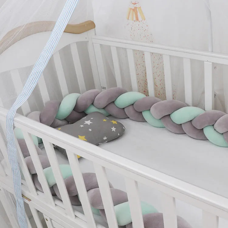 Braided knot baby crib bumper in spandex velvet, shown in light grey colour, flexible and bent to shape.