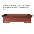 Large rectangular purple clay bonsai pot shown outdoors, highlighting its handmade texture and substantial size.