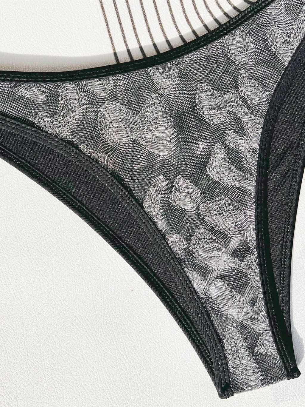 Black women's bikini swimsuit with polyester fabric and strap design