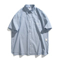 Blue striped loose short-sleeved shirt in cardigan style on a hanger