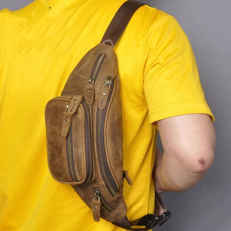 Dark brown leather messenger bag with a single shoulder strap showing its 32cm length and spacious main compartment