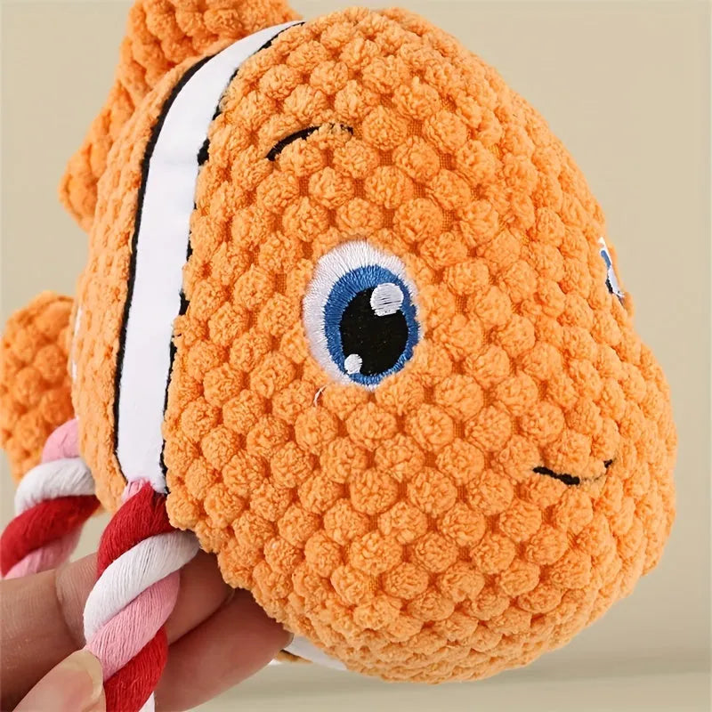 Grey, green, and orange turtle-shaped plush dog toy showing its knotted rope centre.
