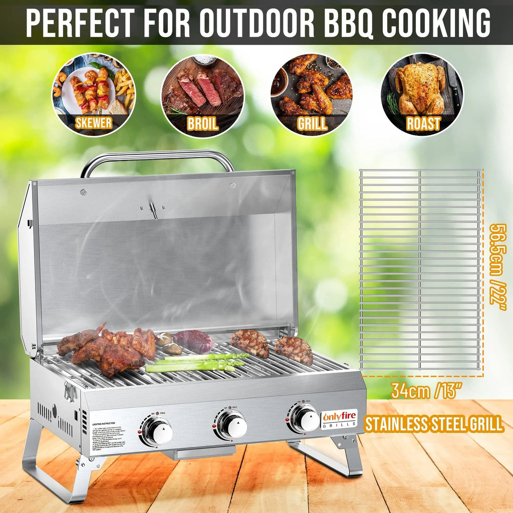 Silver stainless steel desktop gas barbecue grill with three burners and foldable legs.