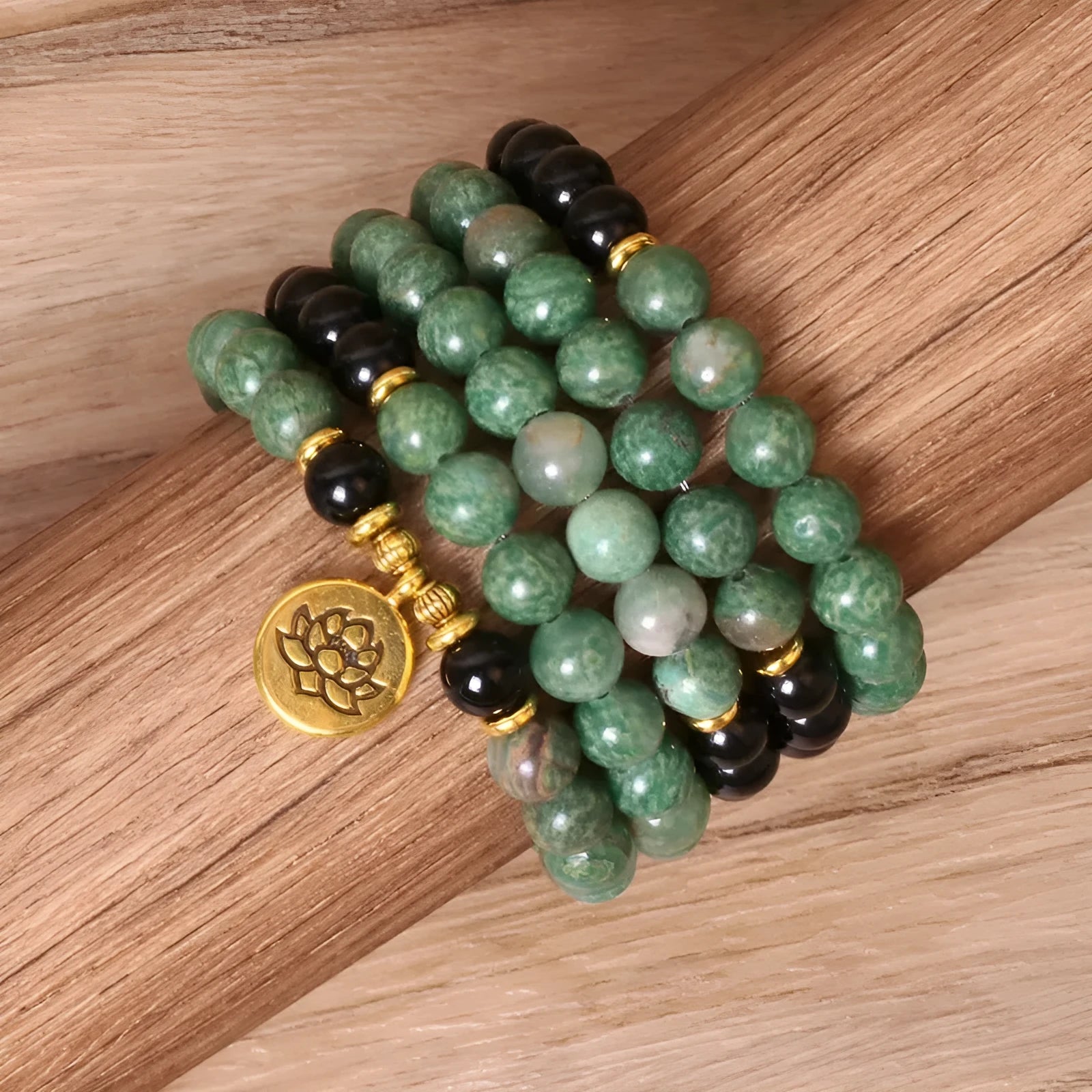 Green and black alloy beaded bracelet on an elastic cord