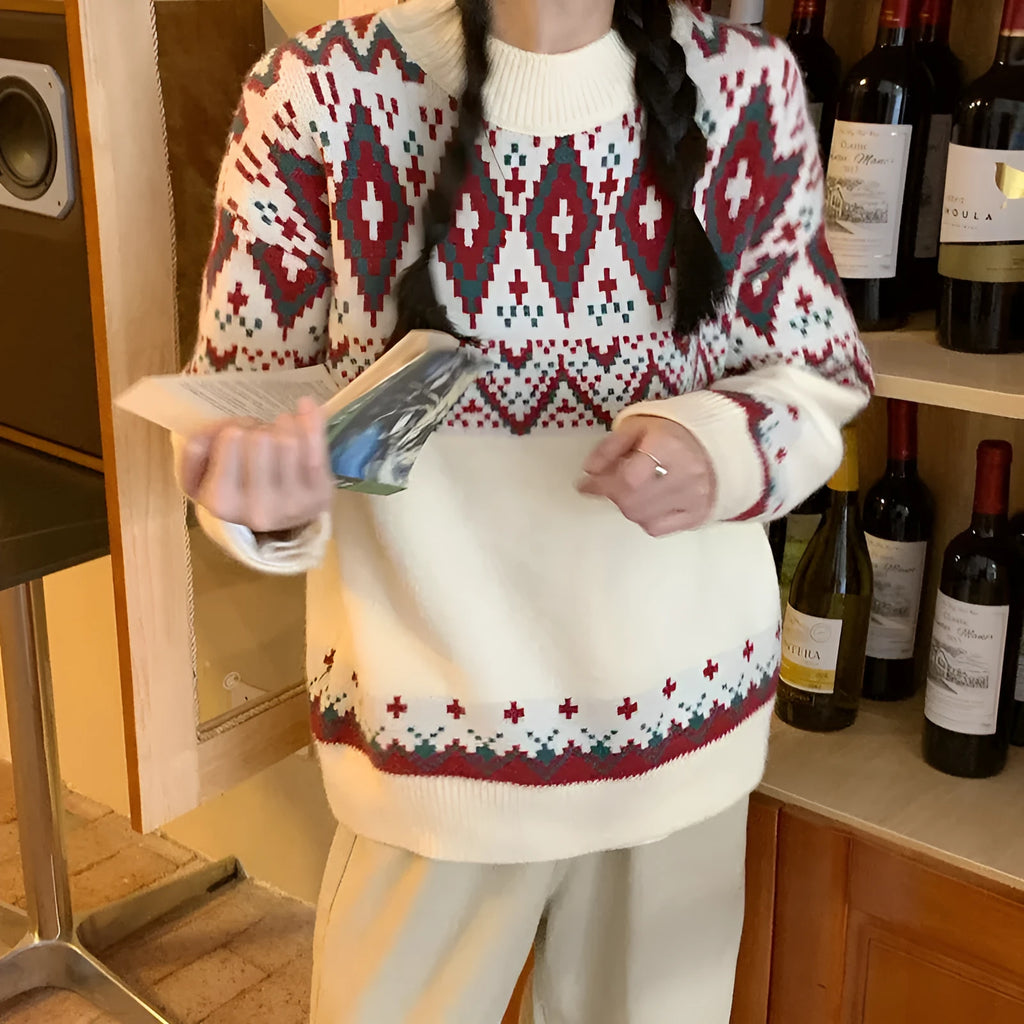 Red and white striped loose fit long sleeve knitted pullover top on a hanger.