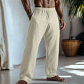Straight leg casual trousers in cotton and linen fabric in a light green colour, shown with side pockets.