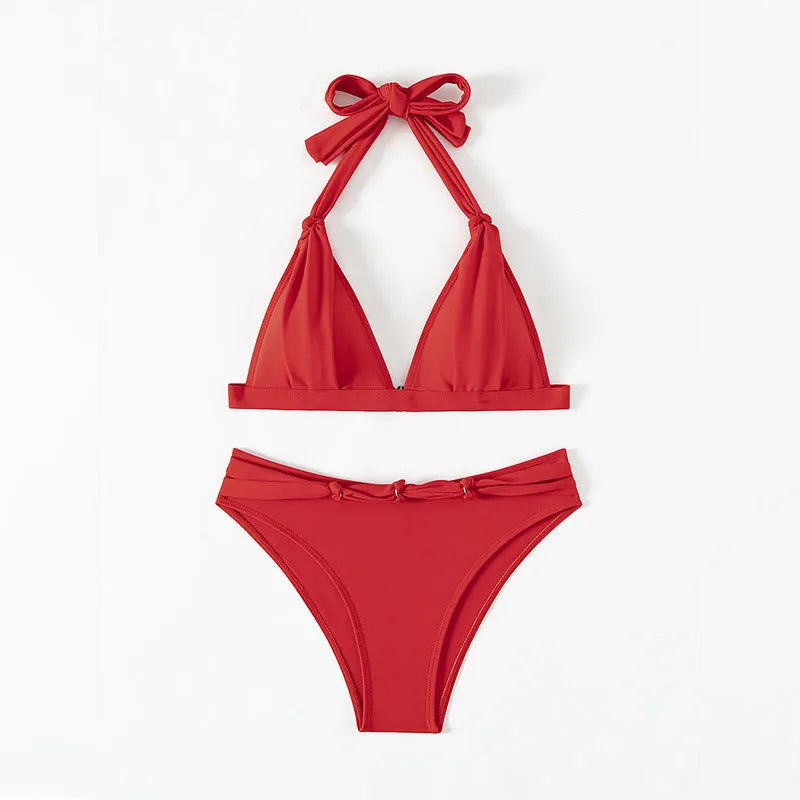 Red women's lace-up halterneck bikini with split shorts for beach swimming