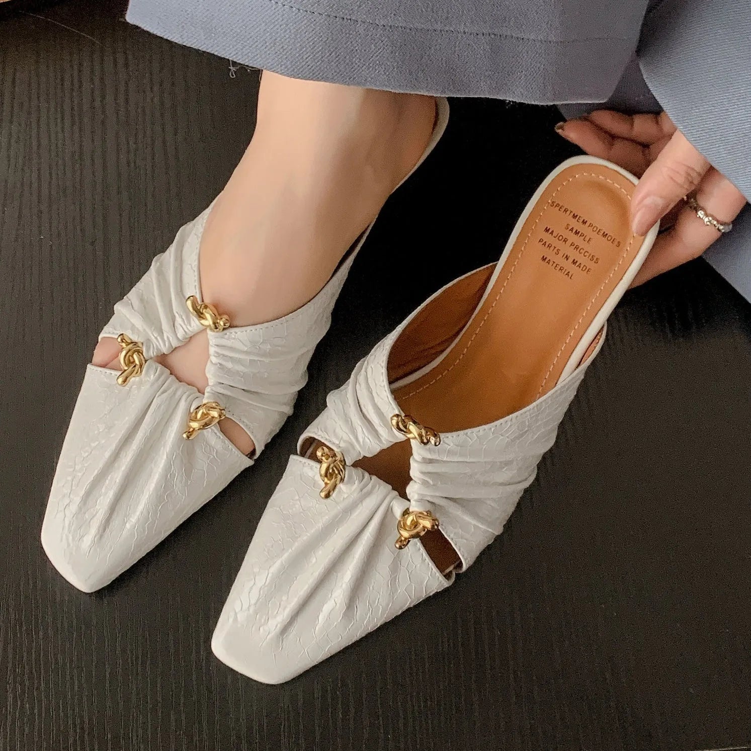 Women's genuine leather half toe cap slippers in gold colour with a low heel and square toe.