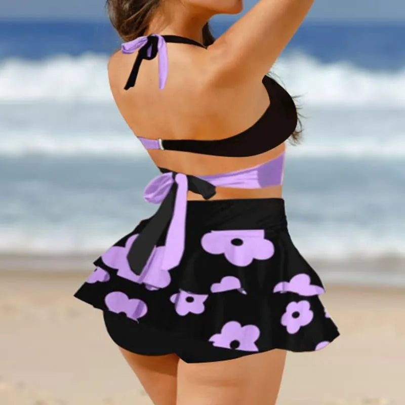 Women's purple bikini swimsuit with matching skirt showing lace-up detail and high waist briefs style