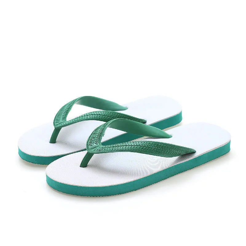 Rubber beach flip-flops in black with a white fish label on the strap, showing non-slip tread pattern.