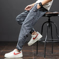 Men's loose fit cargo jeans in blue with straight leg and front pockets.