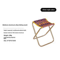 Black aluminium alloy folding stool shown in a folded position for portable storage.