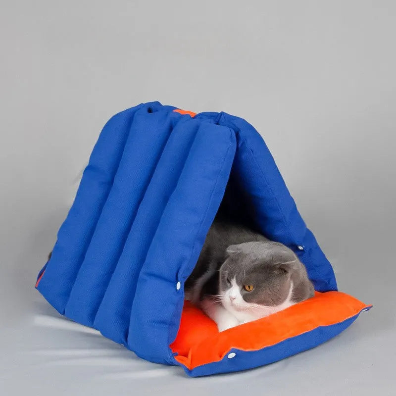 Blue triangular fabric cat nest with visible holes for connection, shown with removable cotton cover.