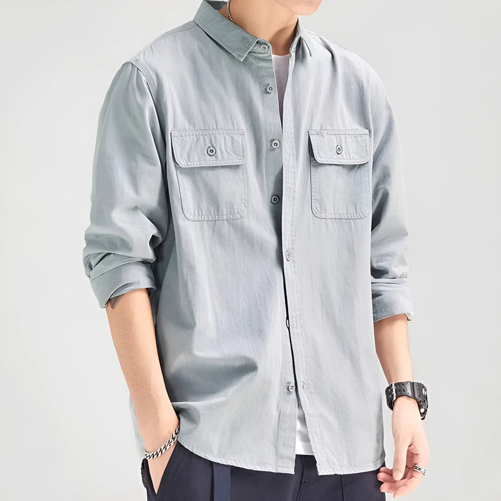 Man wearing a loose-fit grey long sleeve cardigan-style shirt, showcasing its relaxed silhouette and polyester material.
