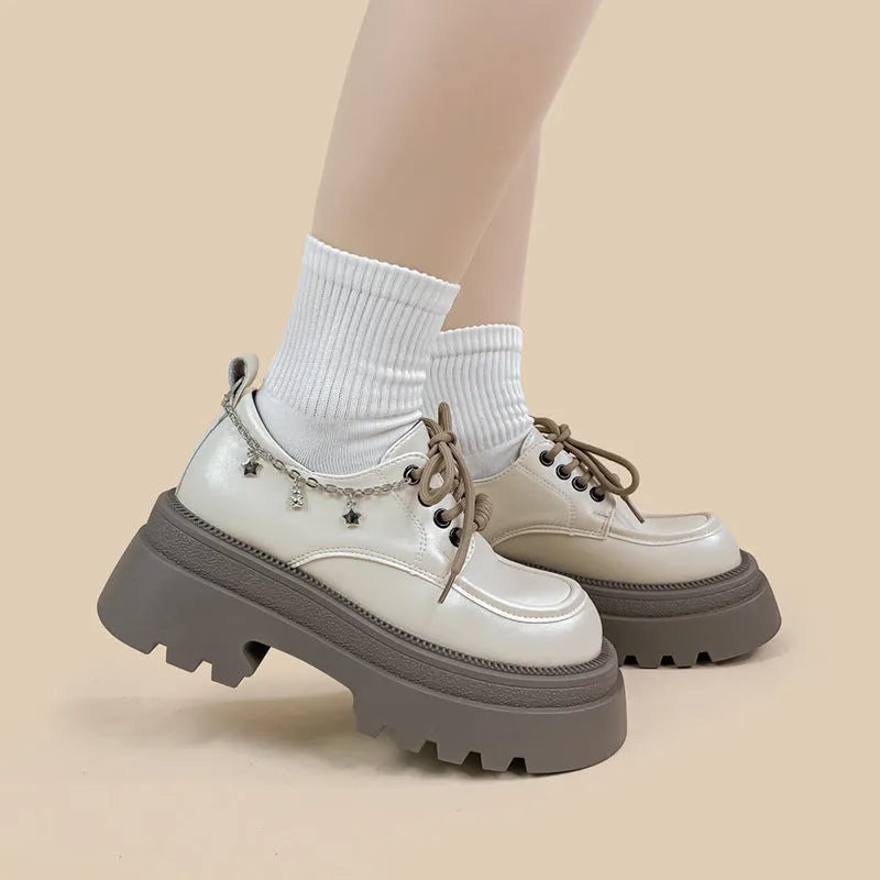 British style white platform leather Mary Jane shoes with chunky heel and lace-up front.