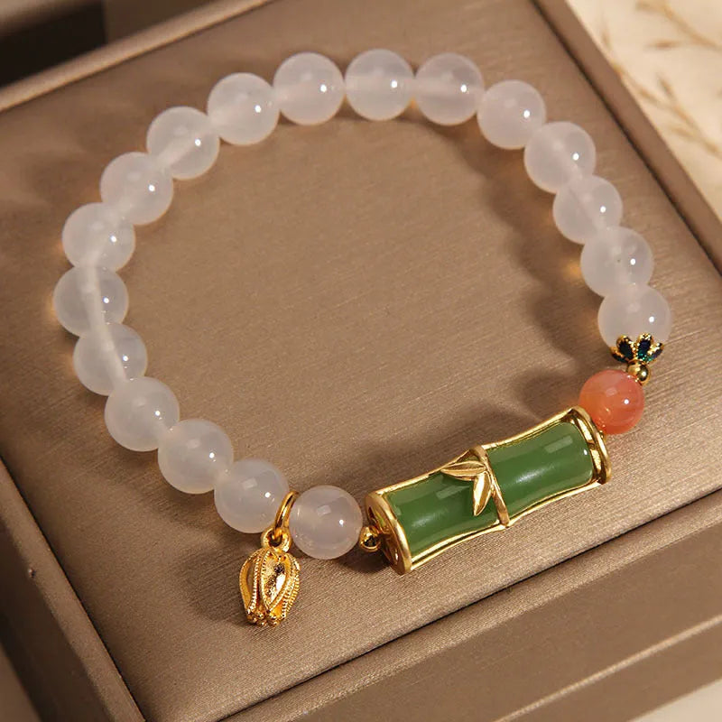 Women's Chinese style beaded bracelet with white agate centre, jade beads, and bamboo joint design.