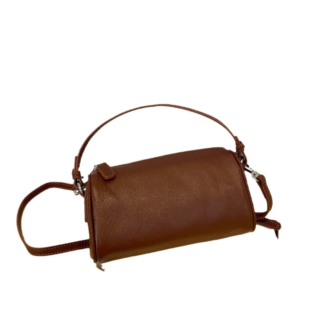 Genuine vegetable tanned leather crossbody phone bag with cylindrical shape and single shoulder strap