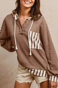 Straw yellow hoodie with waffle texture fabric and striped patchwork panels, featuring a drawstring hood and button neck.