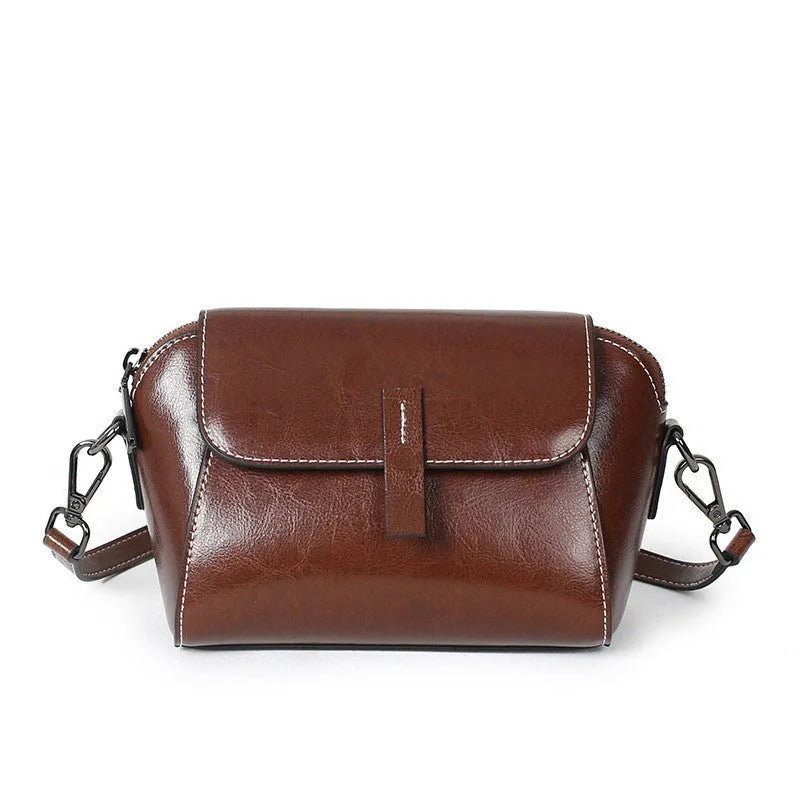 Women's brown oil wax cowhide shell-shaped crossbody messenger bag with visible stitching