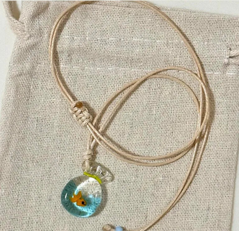 Women's necklace with a coloured glaze joker skirt pendant on a cotton and linen clavicle chain.