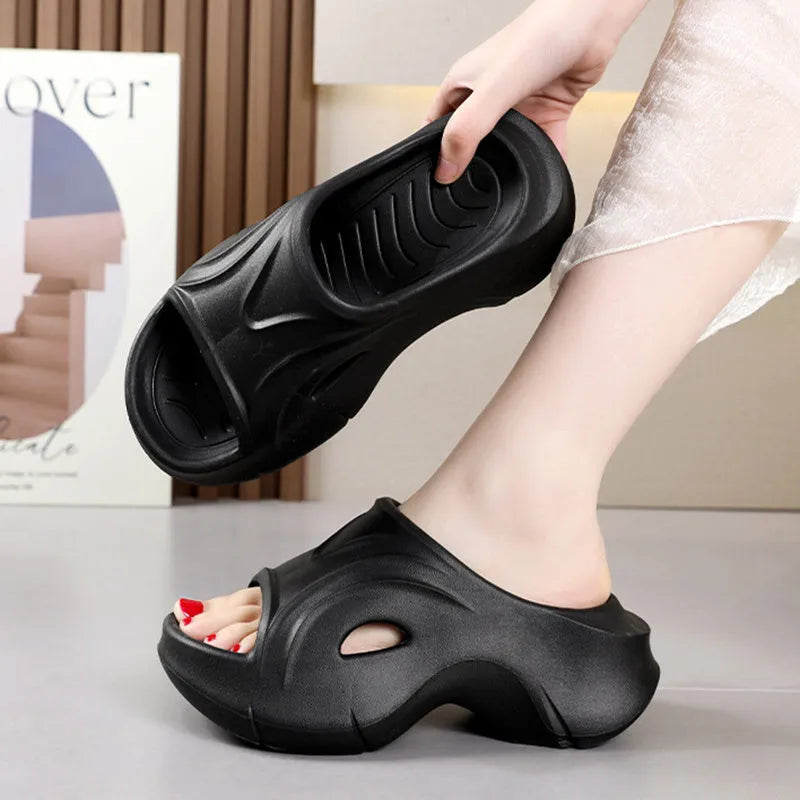 Women's white EVA slippers with thick sole and round toe on sandy beach